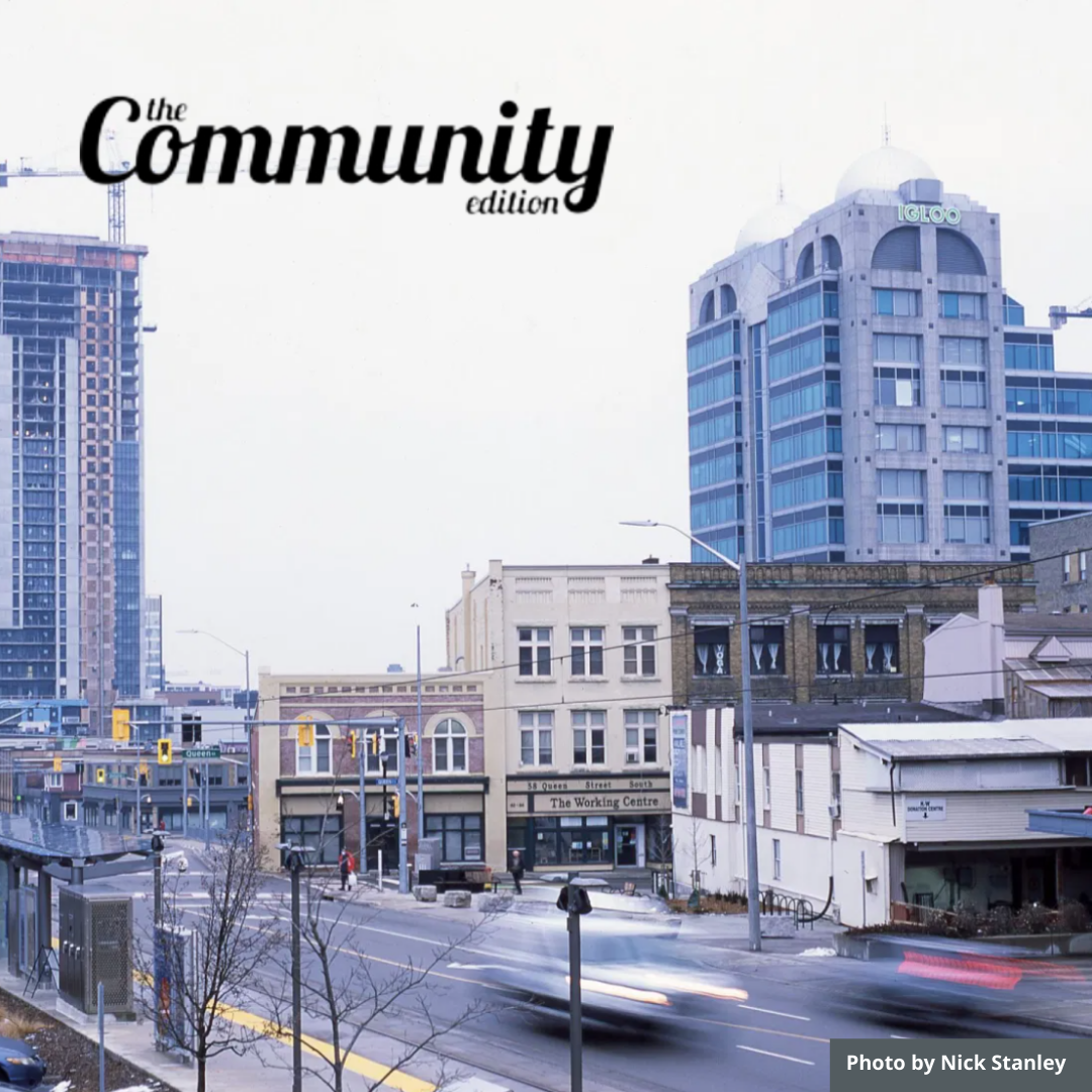 Picture of a city landscape with old buildings and new and in the top left in cursive it says "The Community Edition". Photo taken by Nick Stanley