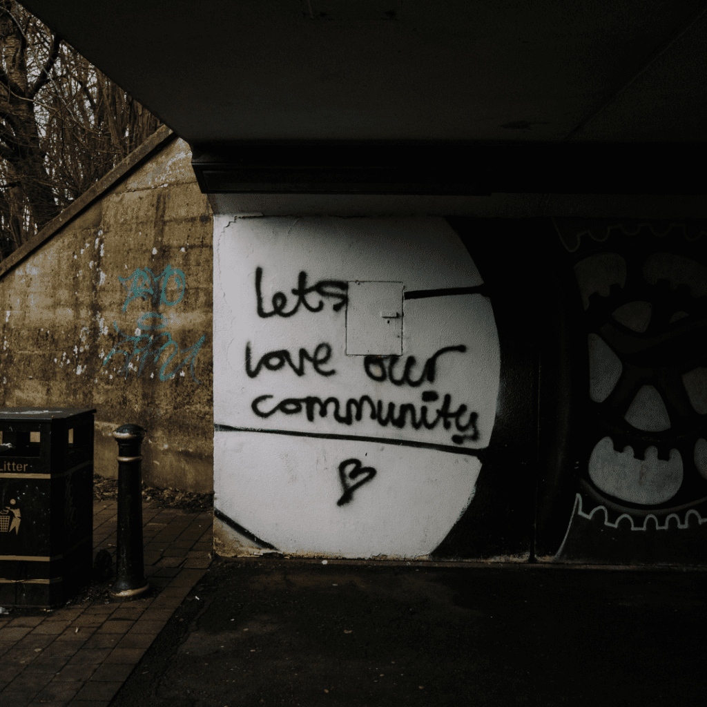 image of graffiti on a brick wall that says "Love your community"