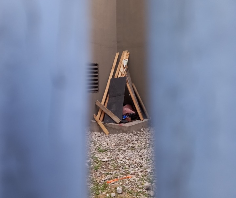 make shift shelter in the corner of a building